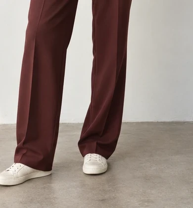 Relaxed trouser drape and light sneakers